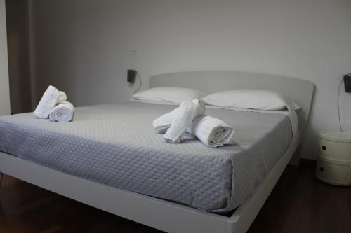 a white bed with towels and pillows on it at B&B San Salvo in San Salvo