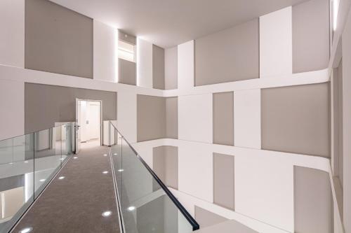 a staircase in a building with white walls at THE ONE CAORLE - Hotel & Apartments in Caorle
