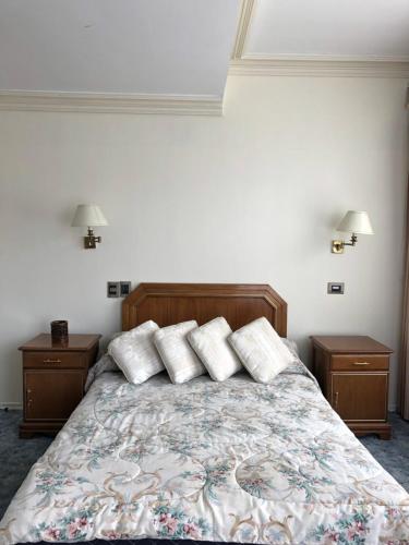 a bedroom with a bed with three pillows on it at B&B 518 in La Paz