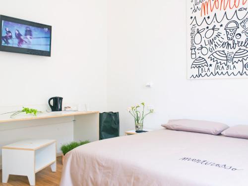 a bedroom with a bed and a tv on a wall at Affittacamere Altamarea in La Spezia