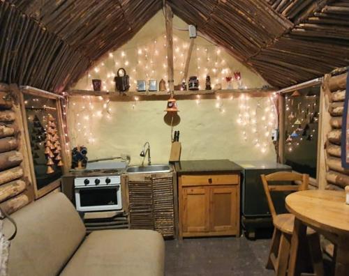 a kitchen with a stove and a couch in a room at Glamping Verde 360 in Guasca