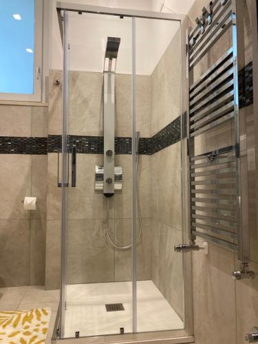 a shower with a glass door in a bathroom at Neptune in Francavilla al Mare