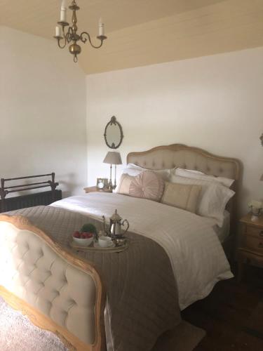 a bedroom with a large bed with a tray of fruit on it at Keenaghan Cottage Belleek Fermanagh Northern Ireland in Belleek