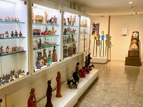 a room filled with lots of toy figurines on display at Kastel Manibu Recife - Boa Viagem in Recife