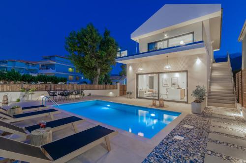 a swimming pool in the backyard of a house at Alas Suites in Alykes