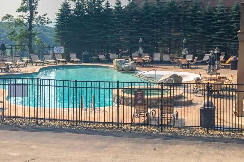 a swimming pool in a park with a fence at Southwind Seven Springs Home on Ski Slopes! in Champion