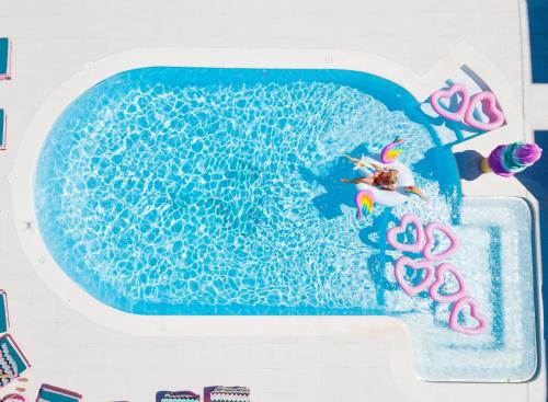 a person in a swimming pool with at Wi-Ki-Woo Boutique Hotel in San Antonio