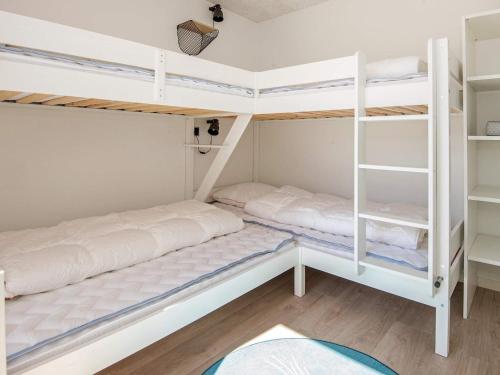 two bunk beds in a small room with wood floors at 10 person holiday home in Juelsminde in Sønderby