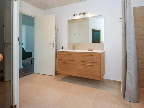 a bathroom with a sink and a mirror at 10 person holiday home in Juelsminde in Sønderby