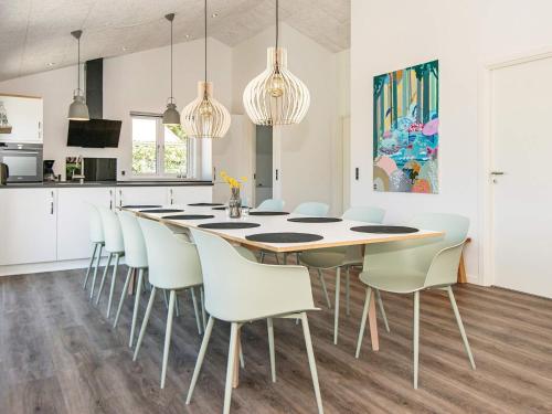 a kitchen and dining room with a table and chairs at 10 person holiday home in Juelsminde in Sønderby