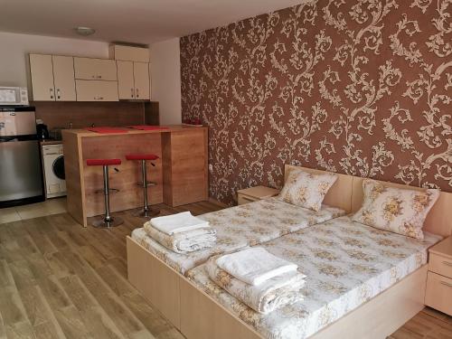 a living room with a couch and a kitchen at Apartment Kraev in Primorsko