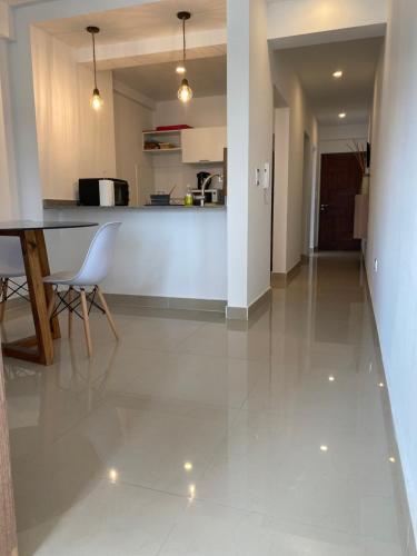 a kitchen and living room with a table and chairs at Departamento Salta in Salta