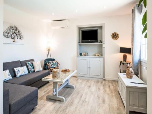 a living room with a couch and a table at Holiday home in La Roquette sur Siane in La Roquette-sur-Siagne