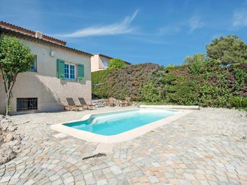 a swimming pool in front of a house at Holiday home in La Roquette sur Siane in La Roquette-sur-Siagne