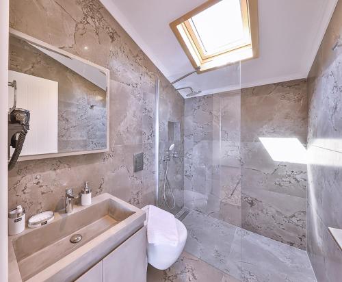 a bathroom with a sink and a shower at Mare Vista Apart in Kaş