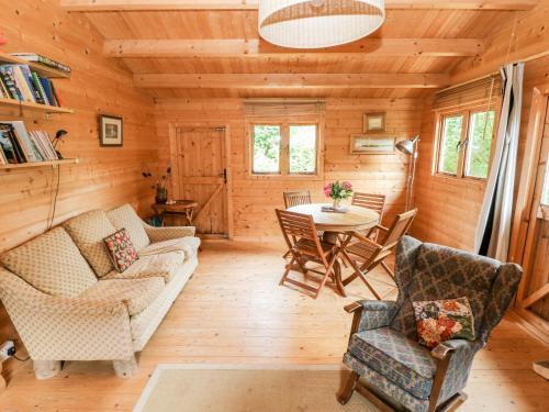 a living room with a couch and a table at The Beach Shack in Carmarthen