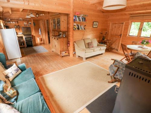 a living room with a couch and a table in a cabin at The Beach Shack in Carmarthen
