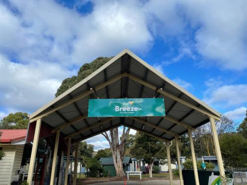 a bus stop with a sign that reads breeze at Breeze Holiday Parks - Grampians in Halls Gap