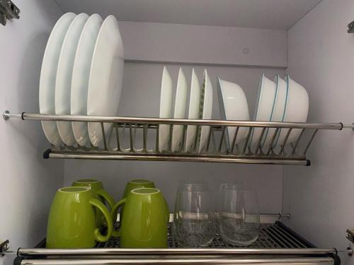 a shelf filled with plates and bowls and glasses at Apartaestudio amoblado centro histórico de Guadalajara de Buga in Buga