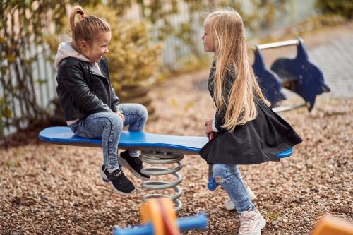 two young girls playing on a playground at Hotel U Valdické brány in Jičín