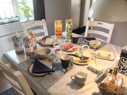 a dining room table with a table set with food at Glemminge Bed and Breakfast in Glemminge