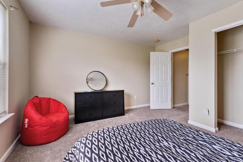 a bedroom with a red chair and a ceiling fan at Incredibly Spacious Carmel Home with Fully Equipped Kitchen - 4700 Sq Ft! Sleeps 15! Pet Friendly! home in Carmel