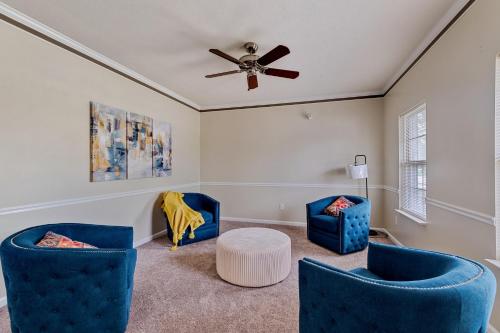 a living room with two blue chairs and a ceiling fan at Incredibly Spacious Carmel Home with Fully Equipped Kitchen - 4700 Sq Ft! Sleeps 15! Pet Friendly! home in Carmel