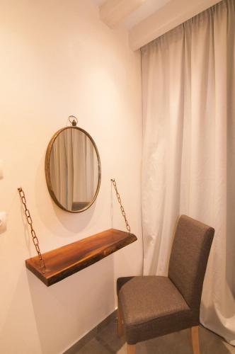 a mirror and a chair in a room at Kyanis Villa , Karpathos Afiartis in Afiartis