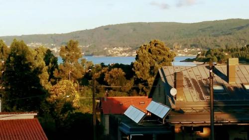 a view of a body of water with trees and buildings at Villa Anselma, casa compartida in Pontevedra