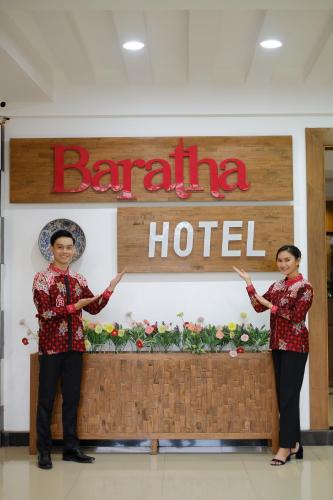 two women standing in front of a baraja hotel at Baratha Hotel & Resto in Bondowoso