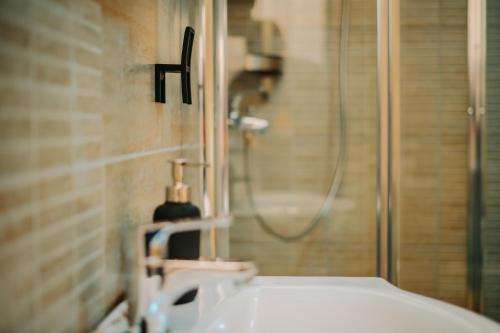 a bathroom with a sink and a shower at Kali Host Home Away From Home in Târgu-Mureş