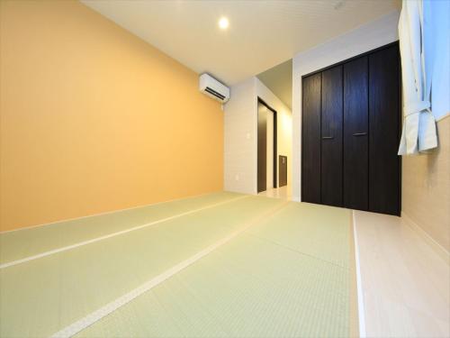 an empty room with a door and a hallway at COTO Tokyo Shibuya 8 in Tokyo