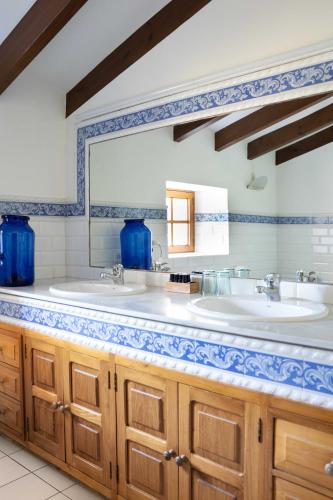a bathroom with two sinks and a mirror at Finca Ca'n Quatre in Sóller
