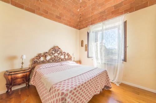 a bedroom with a bed and a large window at Agriturismo SS Annunziata in San Vincenzo