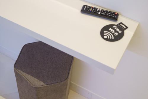 a box sitting on top of a table with a remote control at Caffetteria Luca Suite & Rooms in Bronte