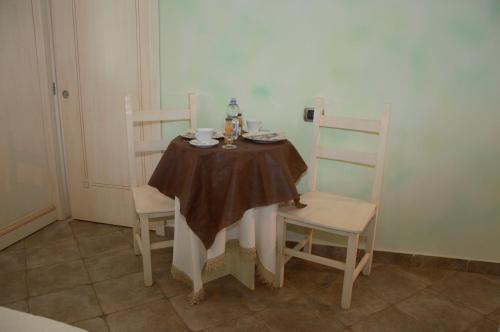 a table with two chairs and a table and a table and chairs at Hotel Sa Cralla Villasimius in Villasimius