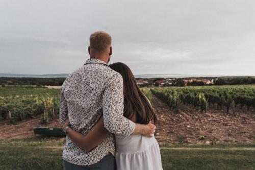 a man and a woman standing in front of a field at Dobosi Birtokközpont in Szentantalfa
