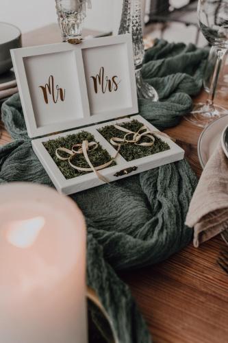 a table topped with two boxes with wedding rings at Dobosi Birtokközpont in Szentantalfa
