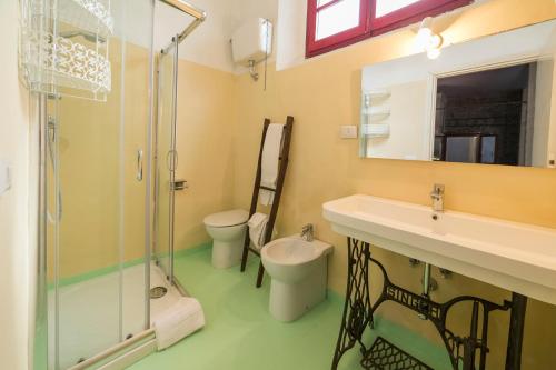 a bathroom with a shower and a sink and a toilet at Agriturismo SS Annunziata in San Vincenzo