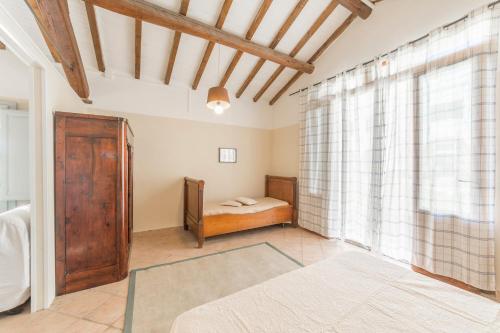 a bedroom with a bed and a window at Agriturismo SS Annunziata in San Vincenzo
