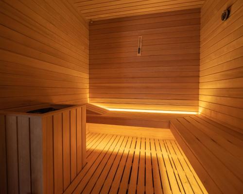 a sauna with a wooden floor and a wooden bench at Agri-Hotel Da Marianna Resort & Spa in Santa Domenica Vittoria