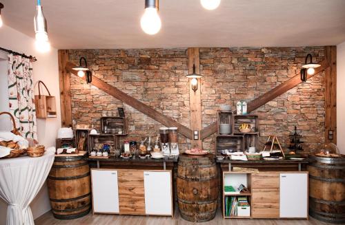 a kitchen with wooden barrels and a brick wall at Hotel Garni Wieshof in Kirchberg in Tirol