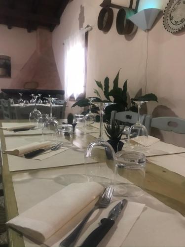 a table with cutlery on top of a table at Agriturismo S´Aranada in Marrùbiu
