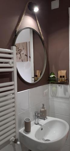 a bathroom with a sink and a mirror at Il Vaso di Creta in Ragusa