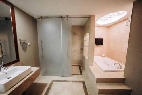 a bathroom with a shower, sink, and toilet at Point Hotel Baku in Baku