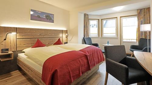 En eller flere senge i et værelse på Landhotel Albers