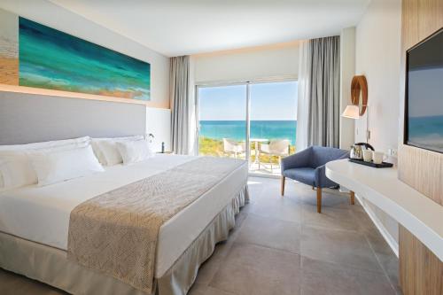a bedroom with a bed and a view of the ocean at Barceló Conil Playa - Adults Recommended in Conil de la Frontera