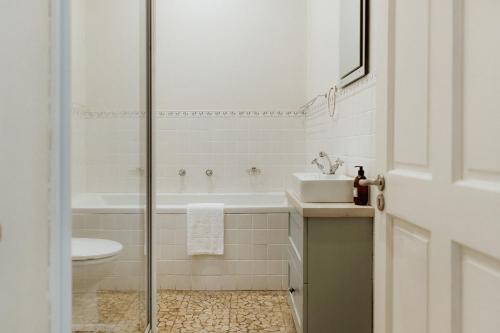 a bathroom with a shower and a sink and a toilet at Phoenix 1 in Paternoster