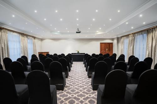 a conference room with chairs and a podium at Premier Hotel Quatermain in Johannesburg