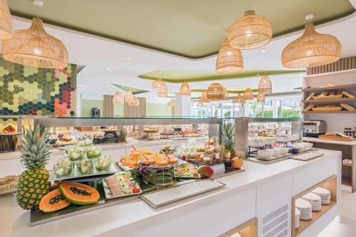 a buffet line with fruits and vegetables on display at Barceló Conil Playa - Adults Recommended in Conil de la Frontera